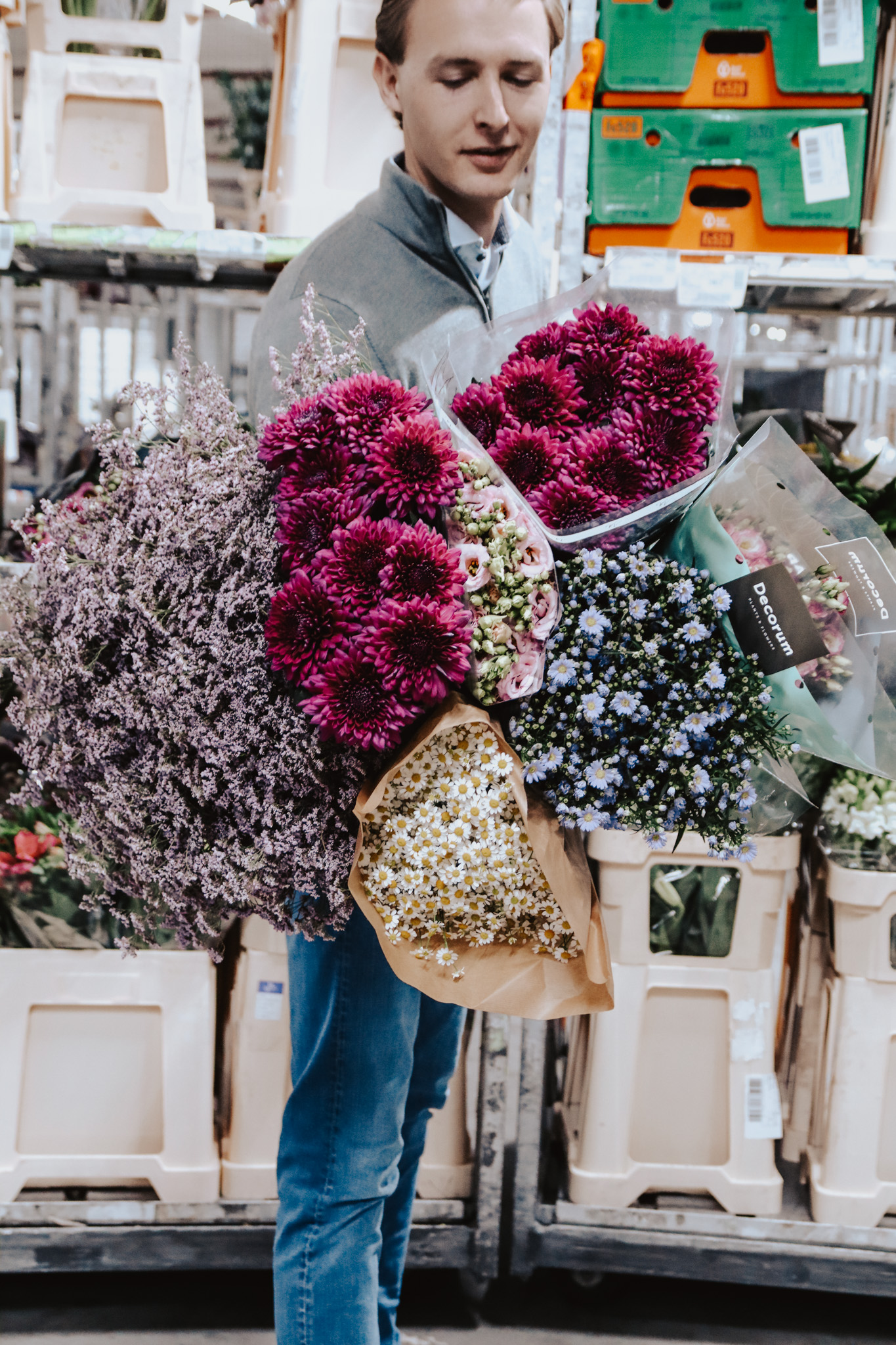 Hands arranging fresh cut stems at the DL Flowers cold store